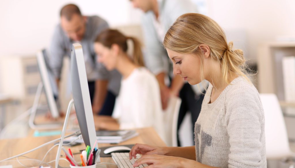 employees working on computers in office